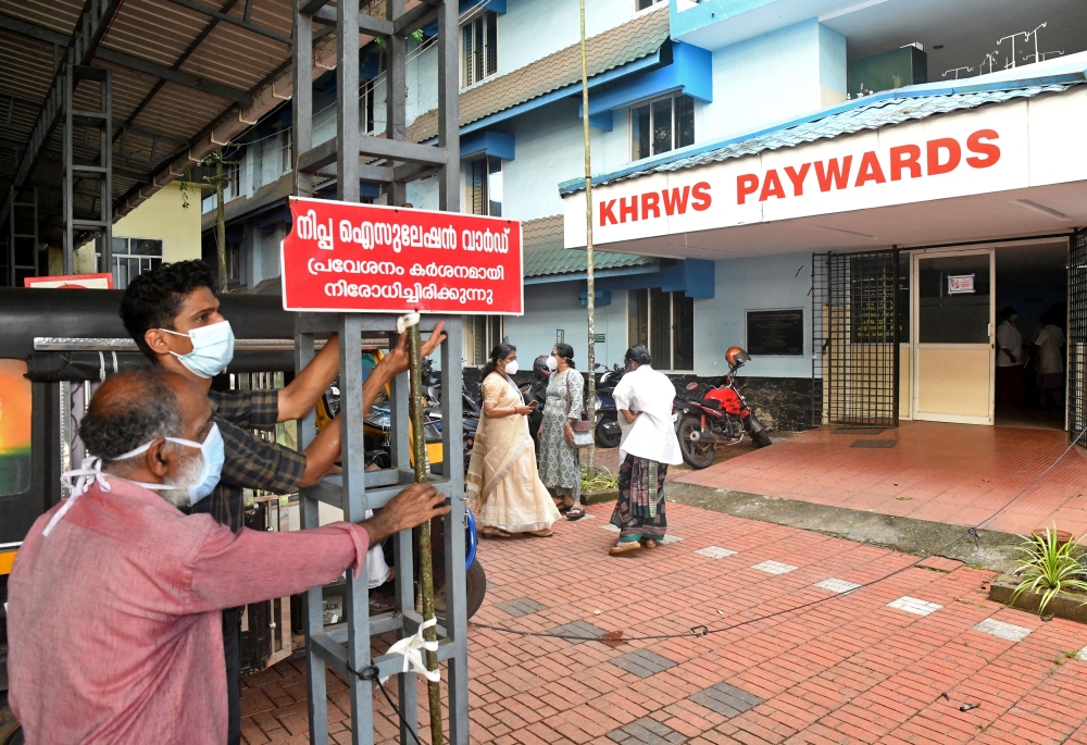Staff members install a sign reading ‘Nipah isolation ward, entry strictly prohibited’ at a hospital where a ward is being prepared for suspected Nipah virus patients in Kozhikode district, Kerala, India. — Reuters pic
