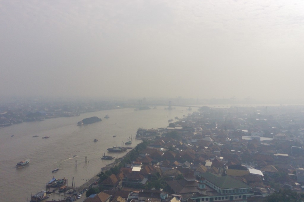 An aerial view shows the Musi river amid haze due to an ongoing wildfire in Palembang, South Sumatra on September 14, 2023. — AFP pic