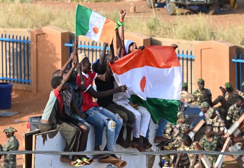 Supporters of Niger's National Council for Safeguard of the Homeland (CNSP) hold a Nigerian flag reading ‘Down with France as they attend the army support concert in front of the Niger and French airbase in Niamey on September 10, 2023. — AFP pic