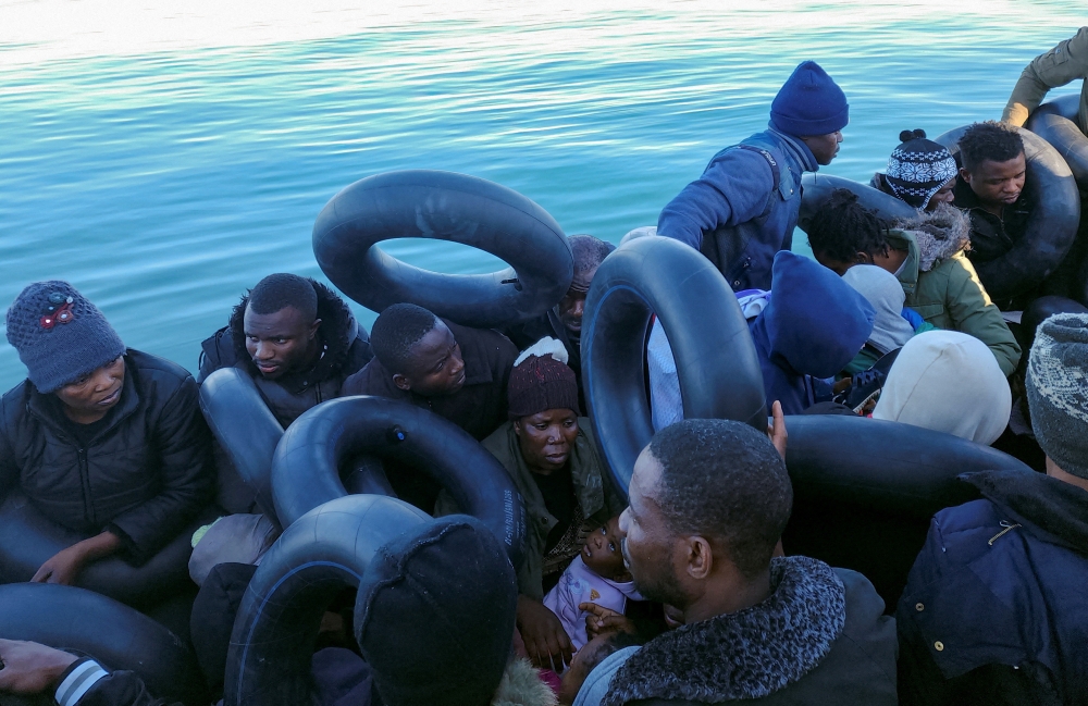 File photo of migrants are pictured on a boat as they are stopped by Tunisian coast guard at sea during their attempt to cross to Italy, off the coast of Sfax, Tunisia April 27, 2023. — Reuters pic