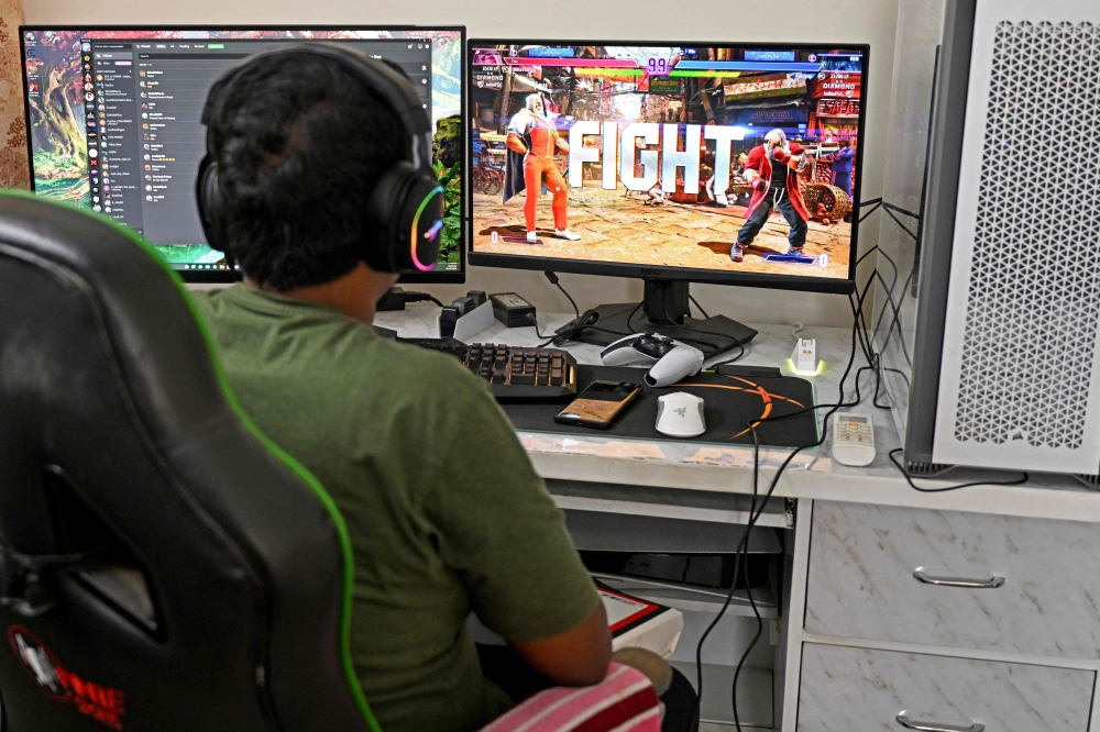 In this photograph taken on July 31, 2023, Mayank Prajapati, an Indian professional esports athlete, plays 'Street Fighter V' at his residence in Gurgaon. — AFP pic
