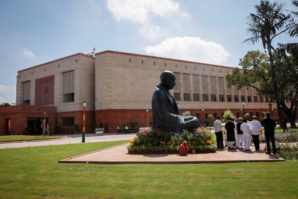 A statue of Mahatma Gandhi is pictured next to India's new parliament building a day before the inauguration of the building in New Delhi September 18, 2023. — Reuters pic