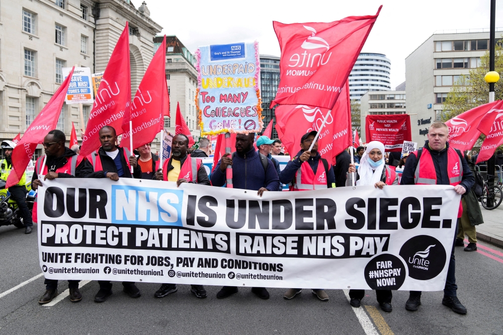 Nurses march towards Trafalgar Square, as striking NHS healthcare staff protest amid an ongoing dispute with the government over pay, in London May 1, 2023. 