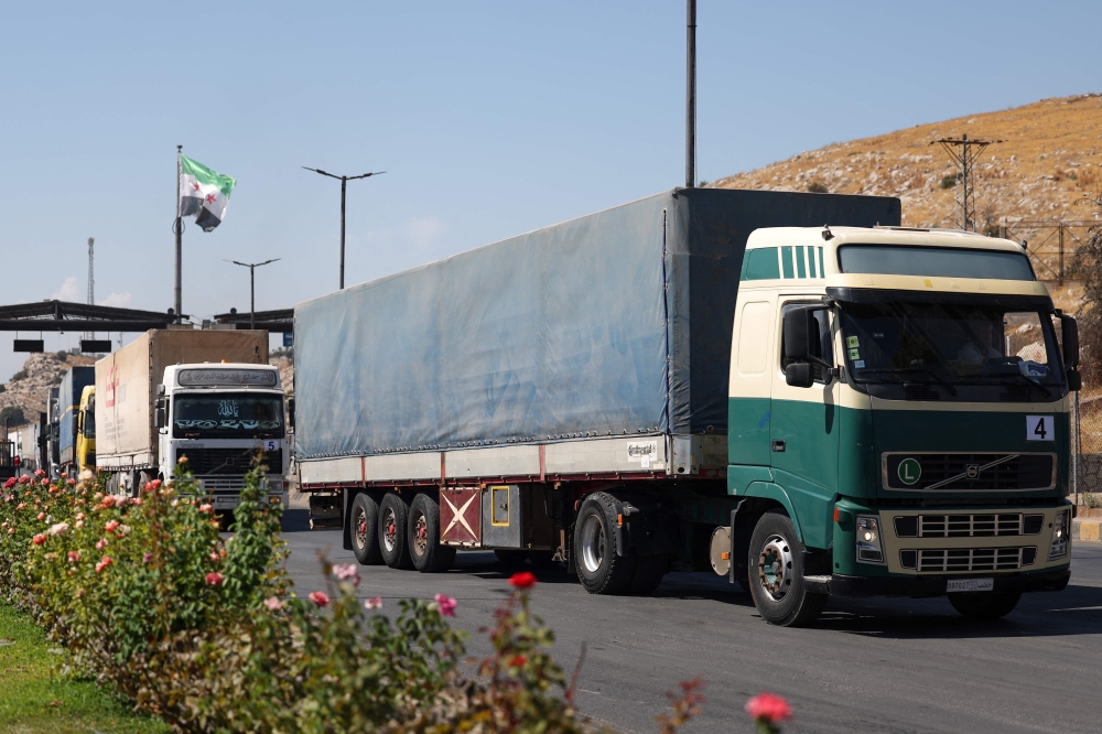 A convoy carrying humanitarian aid arrives in Syria through the Bab al-Hawa border crossing. — AFP pic