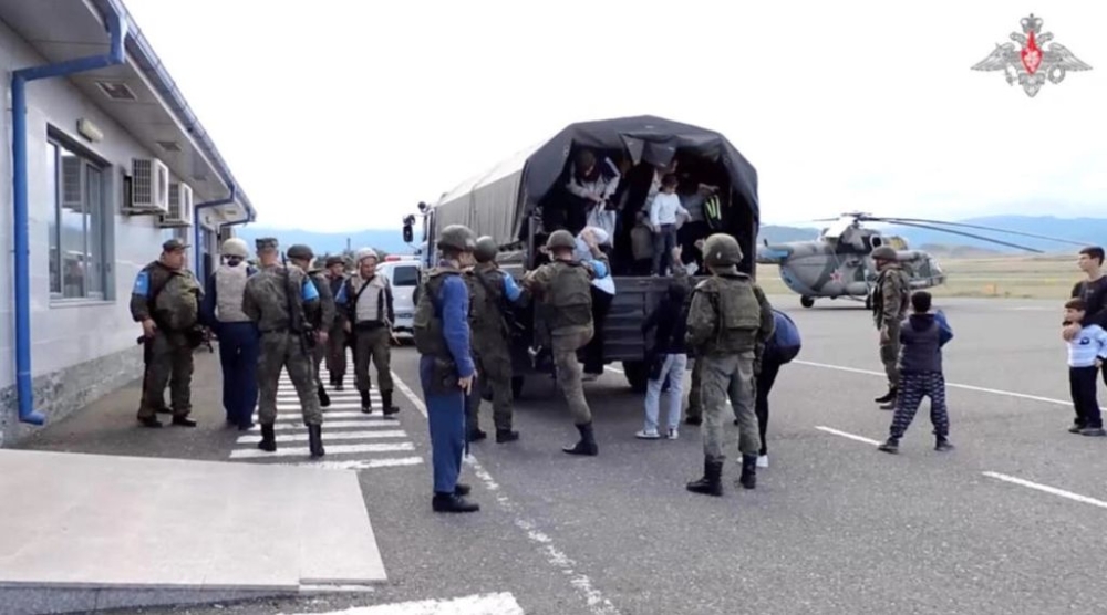 Civilians get out of a truck during an evacuation performed by Russian peacekeepers at an unknown location following the launch of a military operation by Azerbaijani forces in Nagorno-Karabakh, a region inhabited by ethnic Armenians, in this still image from video published on September 20, 2023. — Russian defence ministry handout via Reuters