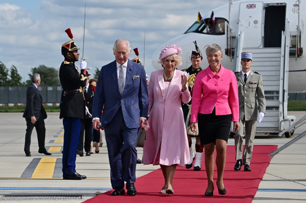 French Prime Minister Elisabeth Borne (right) greets Britain's King Charles III and Britain's Queen Camilla (centre) upon their arrival at the Orly Airport on September 20, 2023, on the first day of a state visit to France. — AFP pic