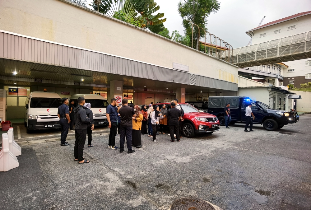 Family members of the victims wait outside the Forensics Department of Putrajaya Hospital, September 20, 2023. — Bernama pic 