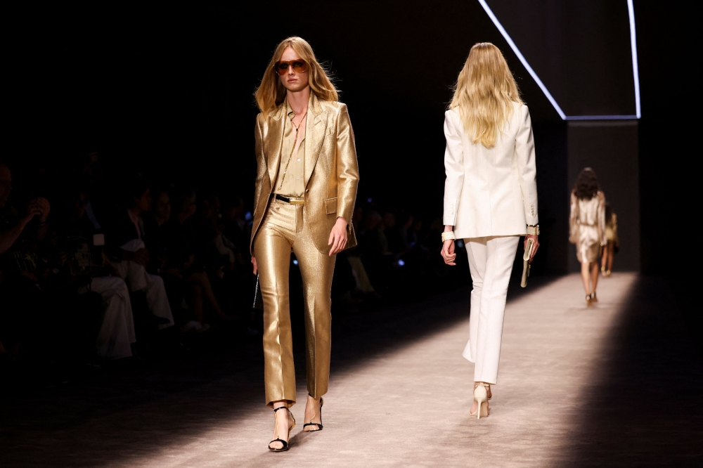 Models wore fitted trouser suits as well as jackets paired with tiny matching shorts, figure-hugging long frocks and short leather dresses. — Reuters pic 