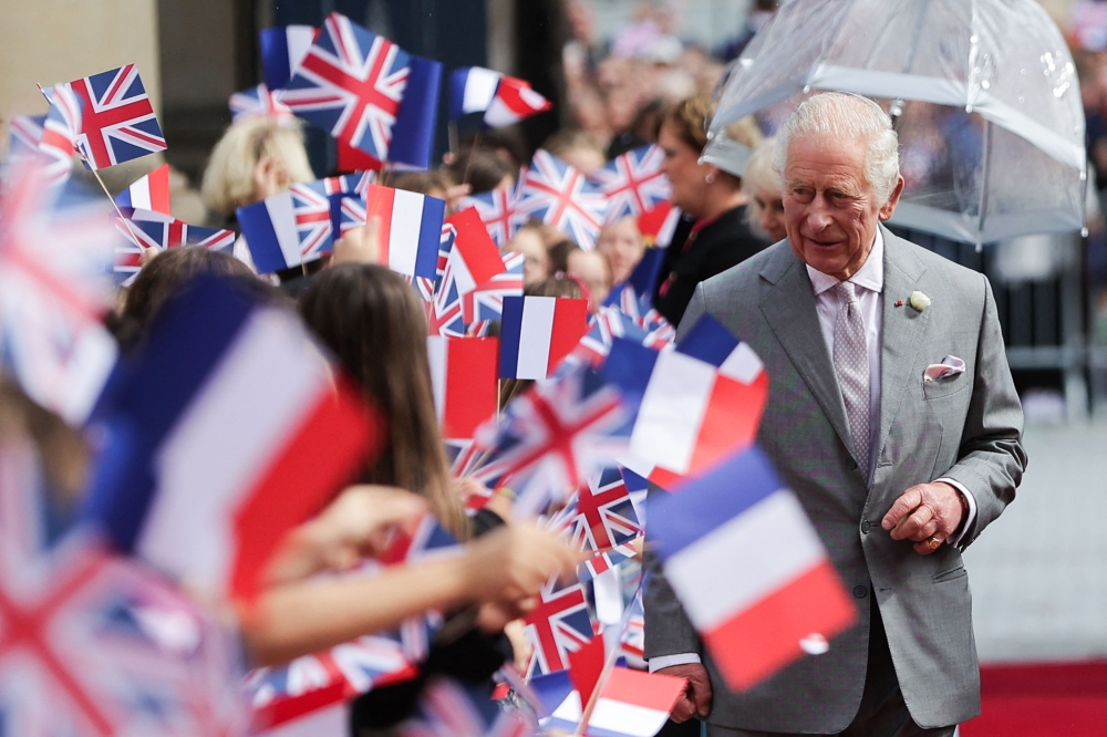 Britain's King Charles III greets fans as he arrives at The Bordeaux's Hotel de Ville (city hall) in Bordeaux, southwestern France, on September 22, 2023. — AFP pic
