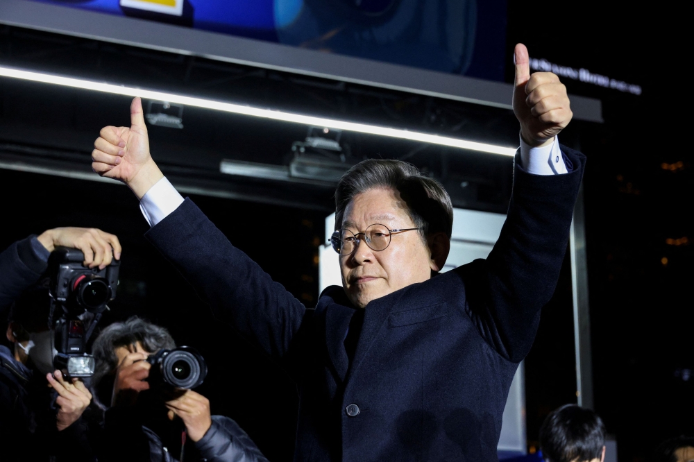 Lee Jae-myung, the presidential candidate of South Korea's then-ruling Democratic Party, gestures during his election campaign rally in Seoul, South Korea March 8, 2022.— Reuters pic