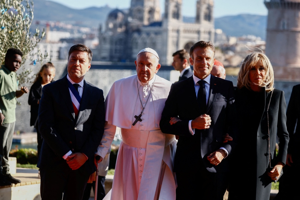 Pope Francis is welcomed by French President Emmanuel Macron and his wife Brigitte Macron, ahead of a meeting at Palais du Pharo, on the occasion of the Mediterranean Meetings (MED 2023), in Marseille, France, September 23, 2023. — Reuters pic