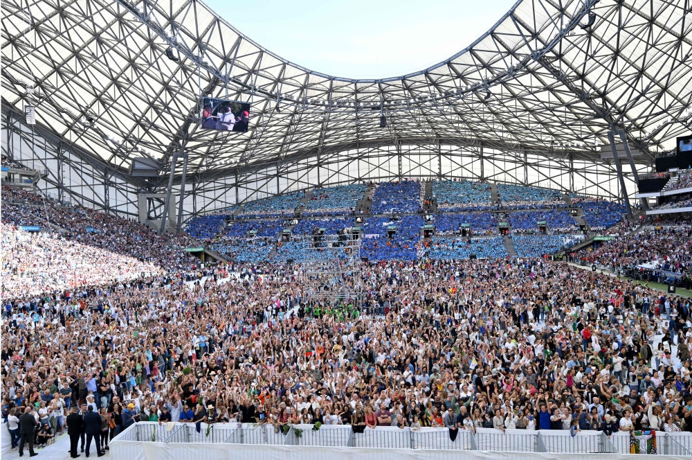 Faithful gather as they wait to celebrate mass, led by Pope Francis, at the Velodrome stadium, in the southern port city of Marseille on September 23, 2023. — AFP pic