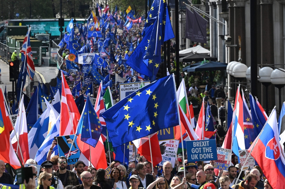 Protesters march from Hyde Park to Palace of Westminster in central London during a rally calling for the UK to rejoin the EU on September 23, 2023. — AFP pic