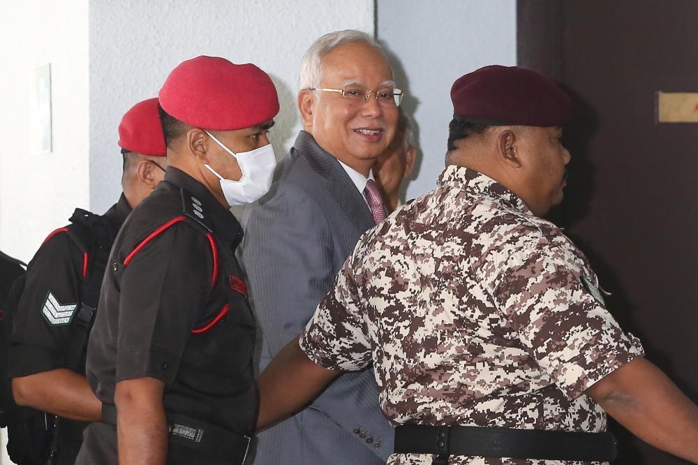 Former prime minister Datuk Seri Najib Razak escorted by Malaysian Prisons officers to stand trial at the Kuala Lumpur High Court Complex on September 18, 2023. — Picture by Yusof Mat Isa
