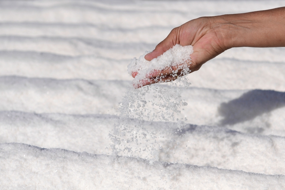 Macu Gomez shows salt put to dry at the 