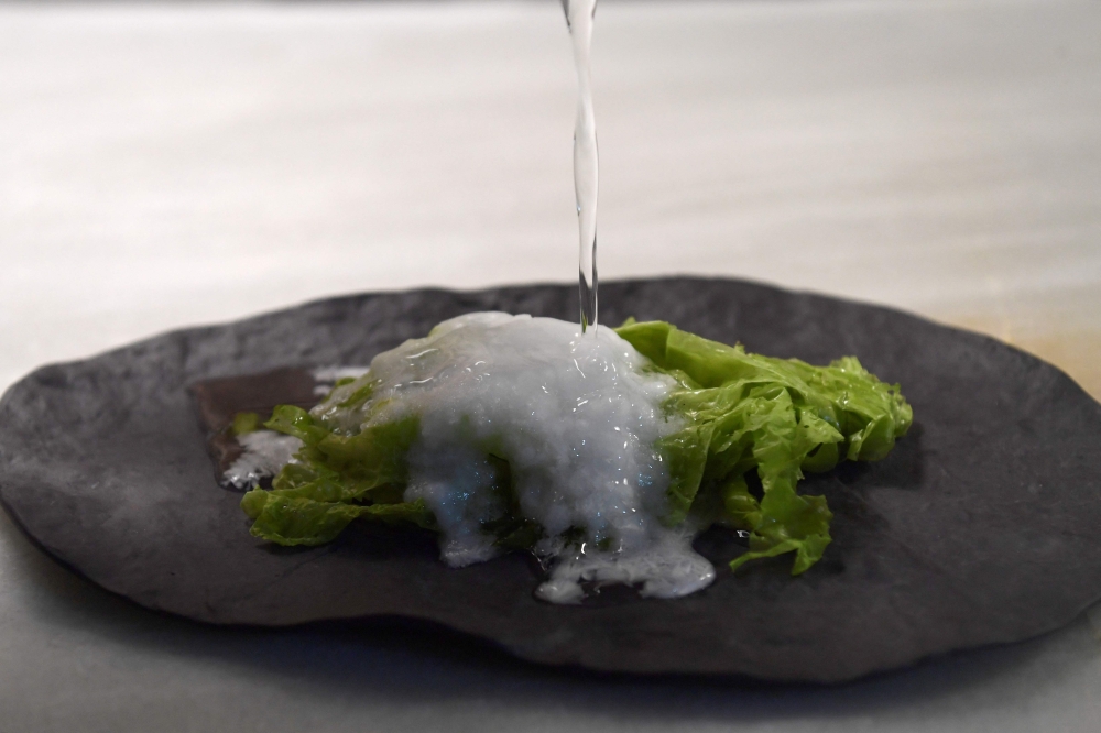 A picture taken on September 15, 2023 shows a view of a dish beeing cooked by salt process at the Aponiente restaurant, in El Puerto de Santa Maria. — AFP pic