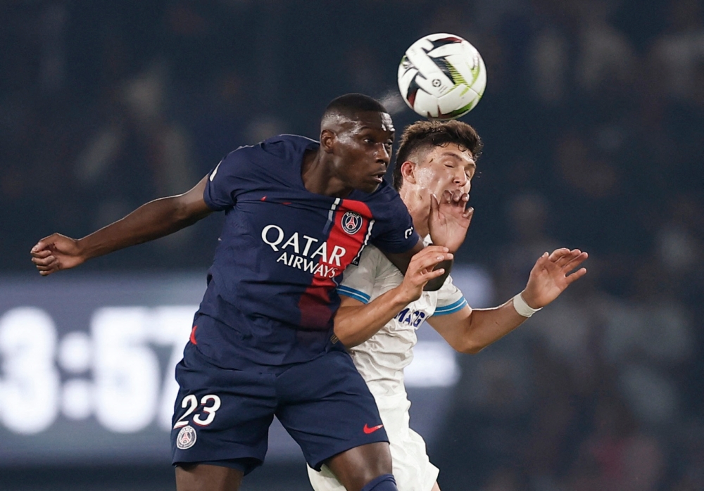 Paris St Germain's Randal Kolo Muani in action with Olympique de Marseille's Leonardo Balerdi at Parc des Princes in Paris September 24, 2023. — Reuters pic
