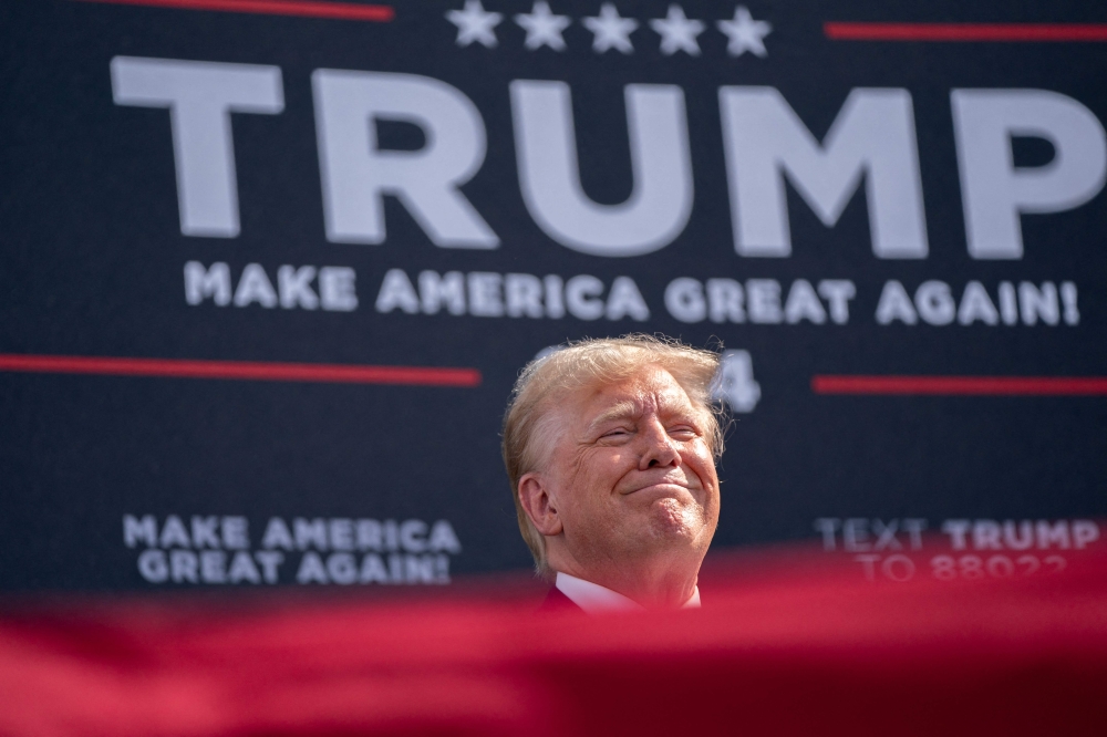 Donald Trump and his sons Eric and Don Jr committed fraud by inflating the value of the real estate and financial assets of the Trump Organization for years, a New York judge ruled yesterday. — AFP pic