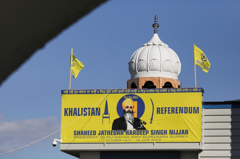 A banner with the image of Sikh leader Hardeep Singh Nijjar is seen at the Guru Nanak Sikh Gurdwara temple, site of his June 2023 killing, in Surrey, British Columbia, Canada. — Reuters pic