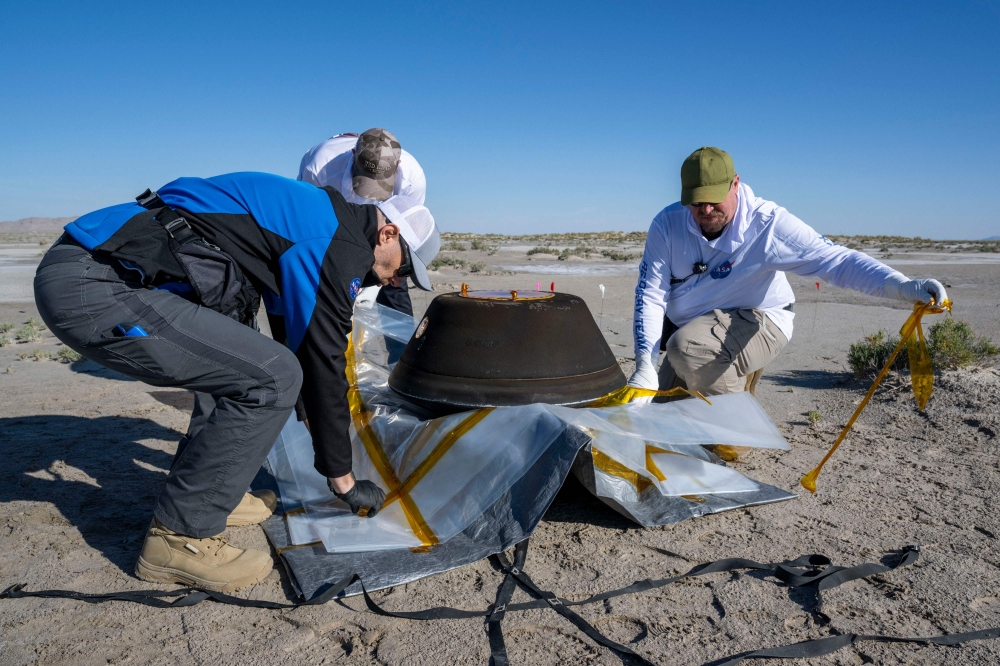 After a seven-year wait, Nasa scientists yesterday finally pried open a space probe carrying the largest asteroid samples ever brought back to Earth, finding black debris. — AFP pic/Nasa/Keegan Barber