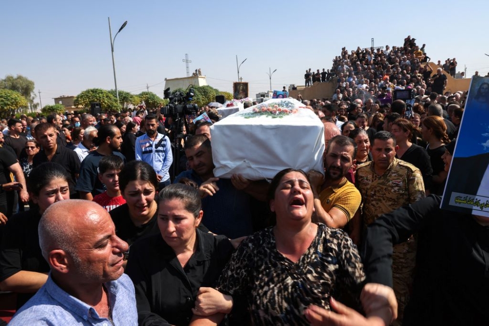 Mourners carry a coffin during the funeral of victims of the fatal fire at a wedding celebration, in Hamdaniya, Iraq, September 28, 2023. — Reuters pic