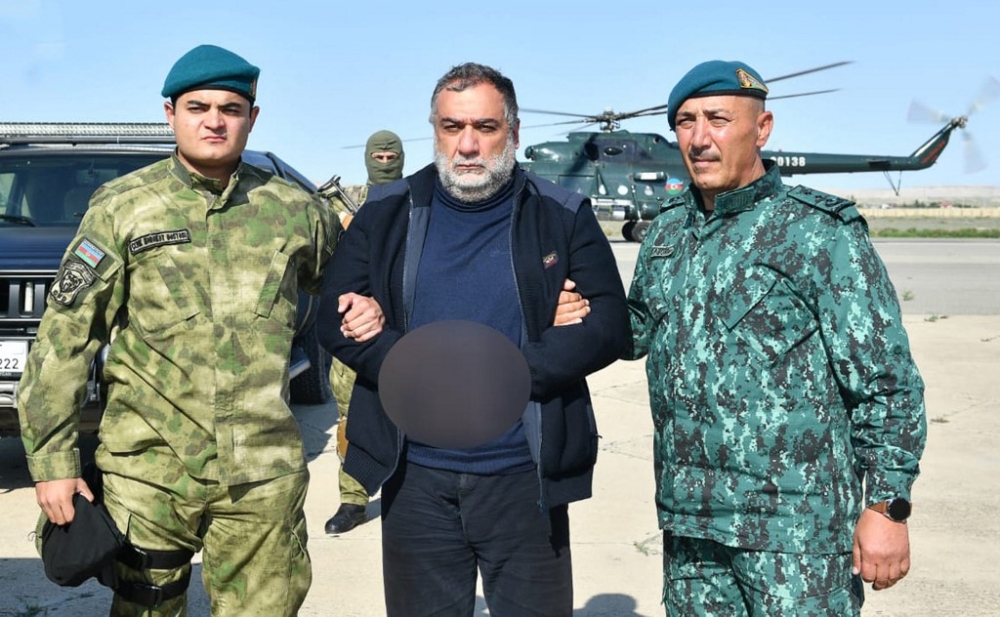 This handout photograph released by State Border Service of Azerbaijan on September 27, 2023, shows Ruben Vardanyan, a former separatist head of Nagorno-Karabakh, detained by two Azerbaijani security officers. Azerbaijan said on September 27, 2023, it had arrested a former separatist leader of Nagorno-Karabakh while he was trying to enter Armenia in the wake of Baku's offensive last week. The state border service said Ruben Vardanyan, a businessman who headed the separatist government from November 2022 until February, had been handed to the 