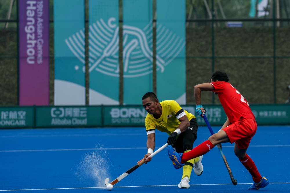 National hockey player Muhammad Razie Abd Rahim is tackled by an Indonesian player during the third match of the Hangzhou 2022 Asian Games at the GongShu Canal Sports Park Stadium in Hangzhou, September 28, 2023. — Bernama pic 