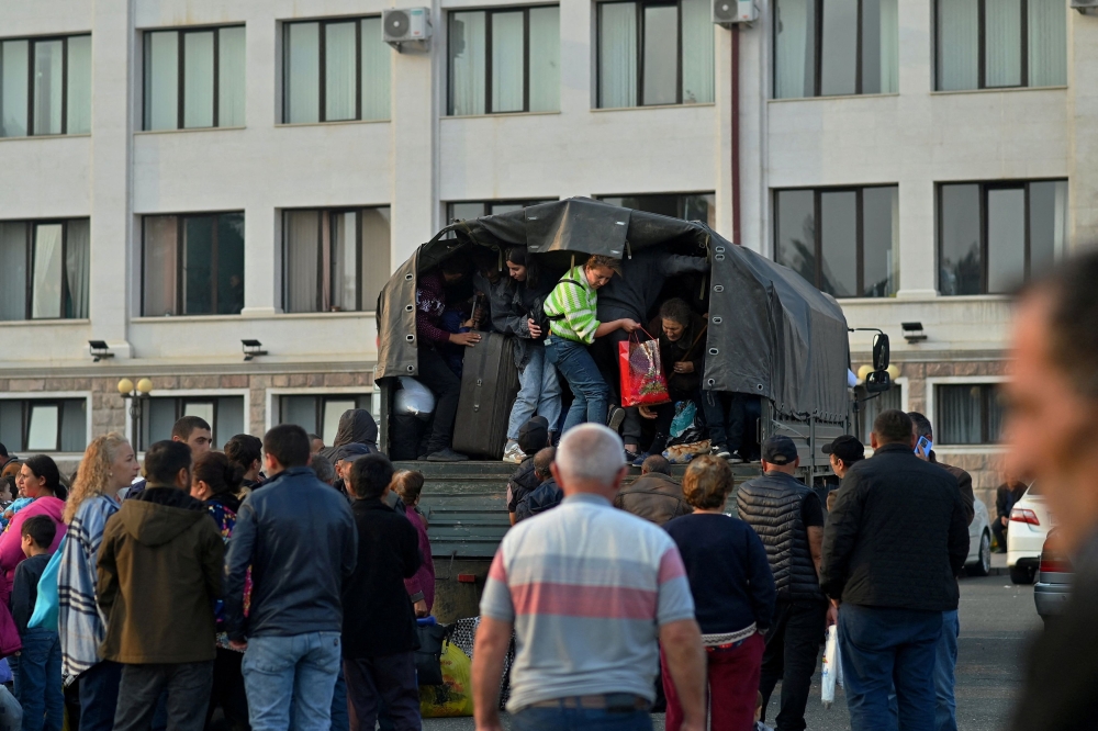 Residents board a vehicle in central Stepanakert before leaving Nagorno-Karabakh, a region inhabited by ethnic Armenians, September 25, 2023. After a lightning operation by Azerbaijan's military to retake control of Nagorno-Karabakh, the stream of ethnic Armenians fleeing the region to Armenia quickly turned into a flood. — Reuters pic