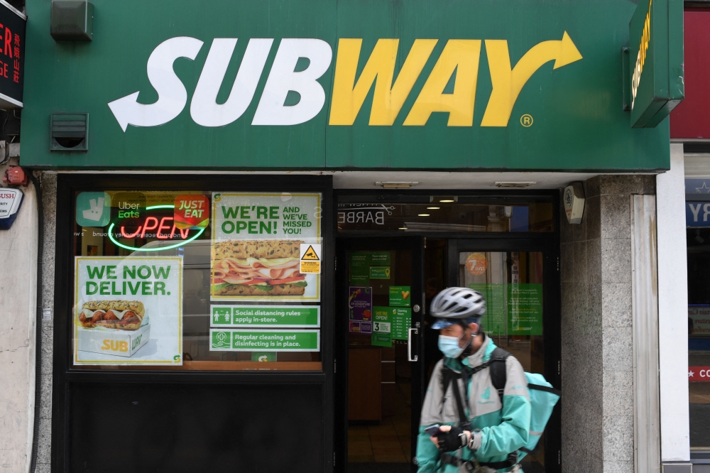 Three big companies in the gig economy — Uber, Doordash and Grubhub — lost a court battle yesterday in New York after a judge upheld a new minimum wage for app-based food delivery workers who became essential during the pandemic. ― AFP file pic
