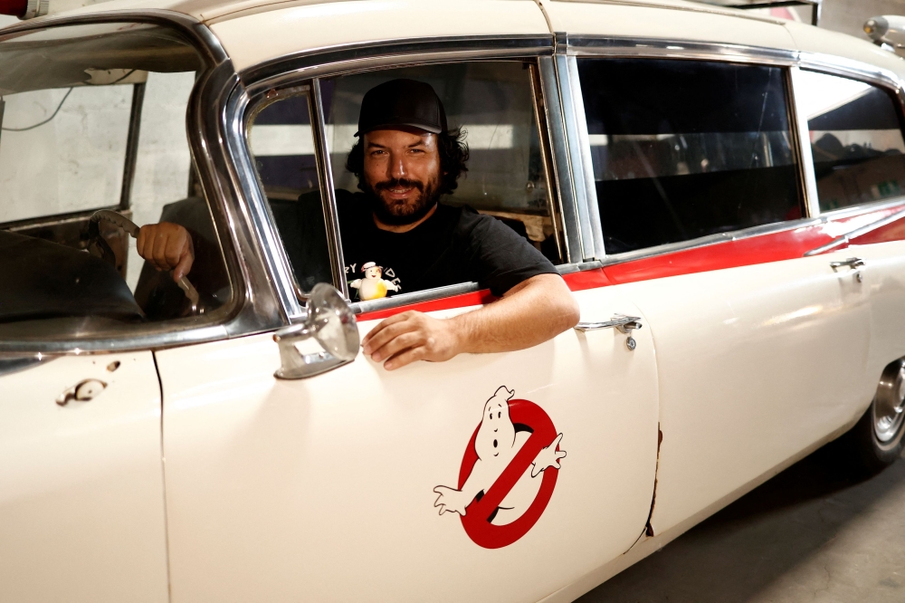 French car collector Franck Galiegue poses in a replica car of the ‘Ghostbusters’ movie. — Reuters pic 