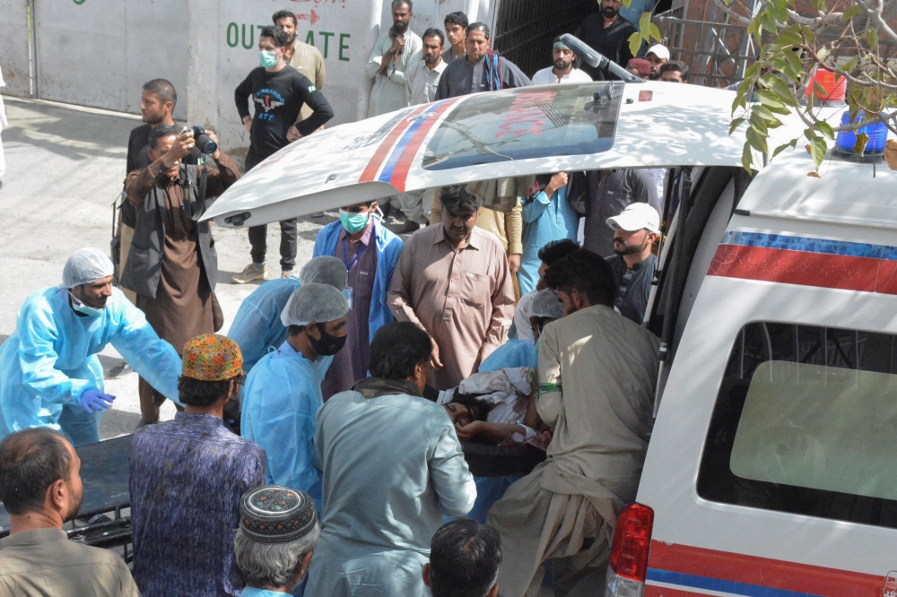 Men and paramedic staff transfer a man, who was injured in a blast in Mastung, from an ambulance outside hospital in Quetta, Pakistan September 29, 2023. — Reuters pic 
