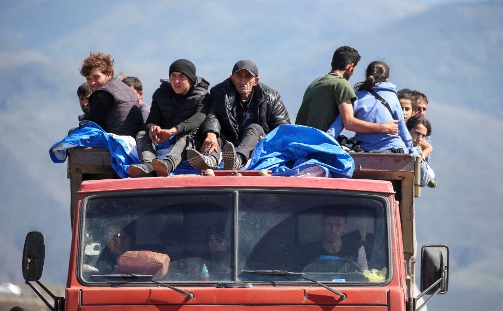File photo of refugees from Nagorno-Karabakh region ride in a truck upon their arrival at the border village of Kornidzor, Armenia, September 27, 2023. — Reuters pic