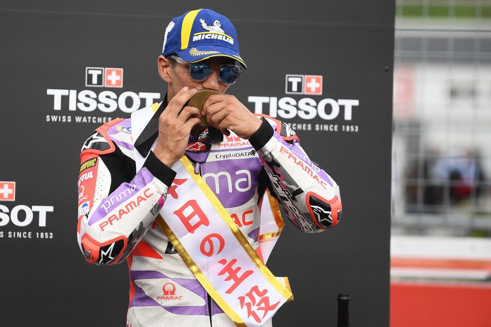 Wearing a sash that reads 'Hero of the Day', sprint race winner Prima Pramac Racing rider Jorge Martin of Spain kisses his gold medal on the podium following the sprint race of the MotoGP Japanese Grand Prix at the Mobility Resort Motegi in Motegi. — AFP pic