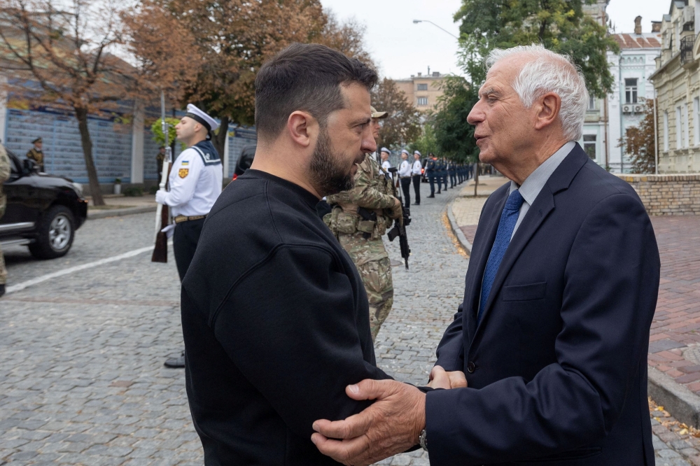 Ukraine's President Volodymyr Zelenskiy speaks with European Union Foreign Policy Chief Josep Borrell as they visit the Memory Wall of Fallen Defenders of Ukraine, amid Russia's attack on Ukraine, during the marking of Defenders of Ukraine Day in Kyiv, Ukraine October 1, 2023.  — Ukrainian Presidential Press Service handout via Reuters