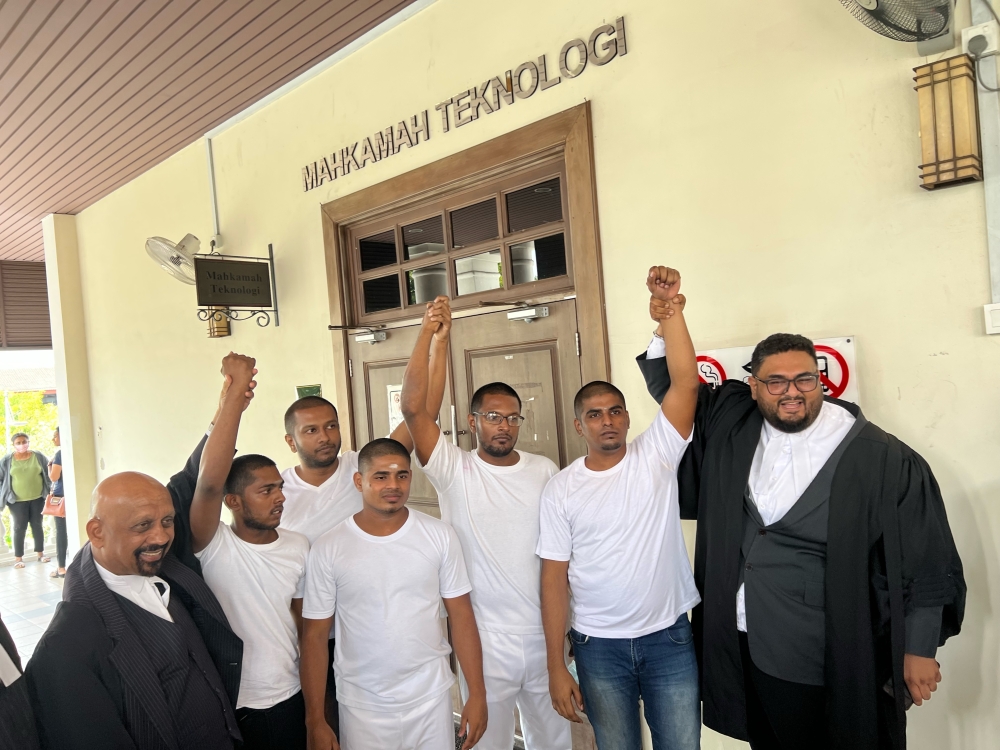 The five men and their lawyers, Datuk Naran Singh (left) and Manveer Singh (right), outside the courtroom. — Picture by Opalyn Mok