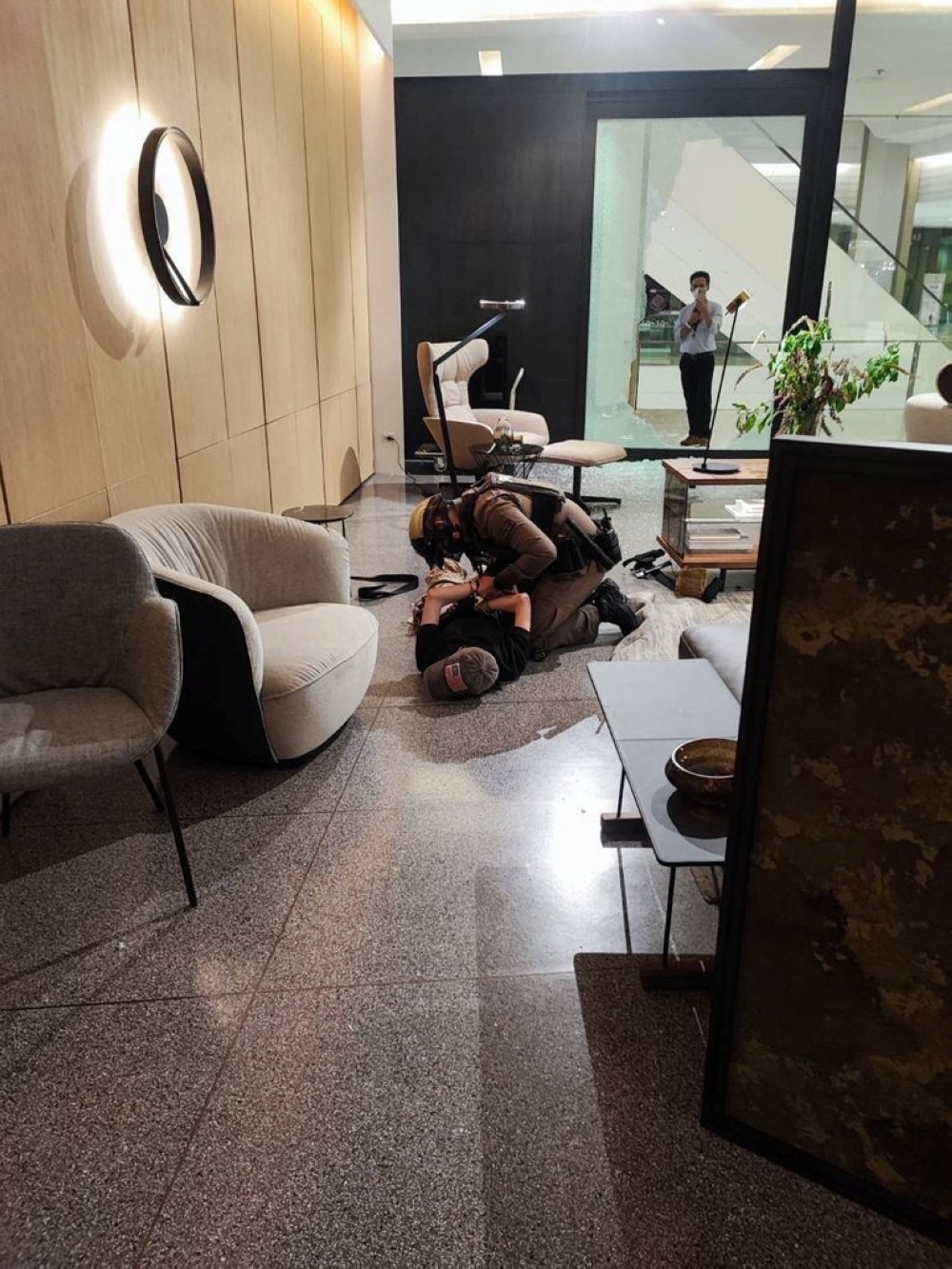 A suspected gunman is detained following shots fired at the luxury Siam Paragon shopping mall, in Bangkok, Thailand, October 3, 2023. — Thai rescue workers association handout pic via Reuters 