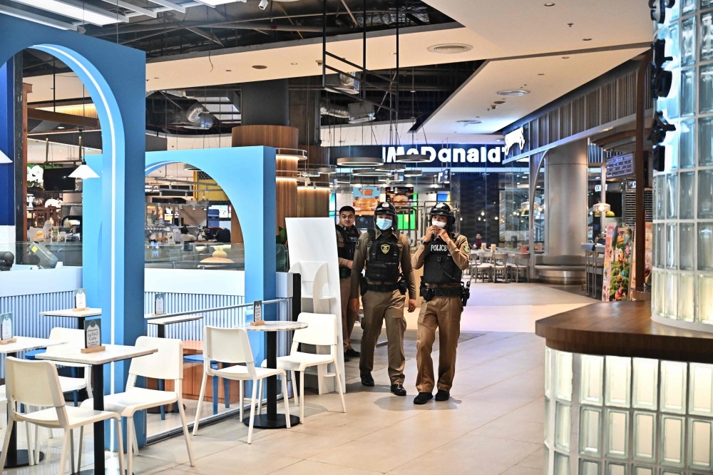 Thai police in Siam Paragon, a day after shooting left two people dead. — AFP pic