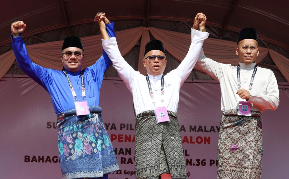 (From left) BN candidate Datuk Amizar Abu Adam, PAS’ Kasim Samat, and Haslihelmy DM Zulhasli. — Bernama pic