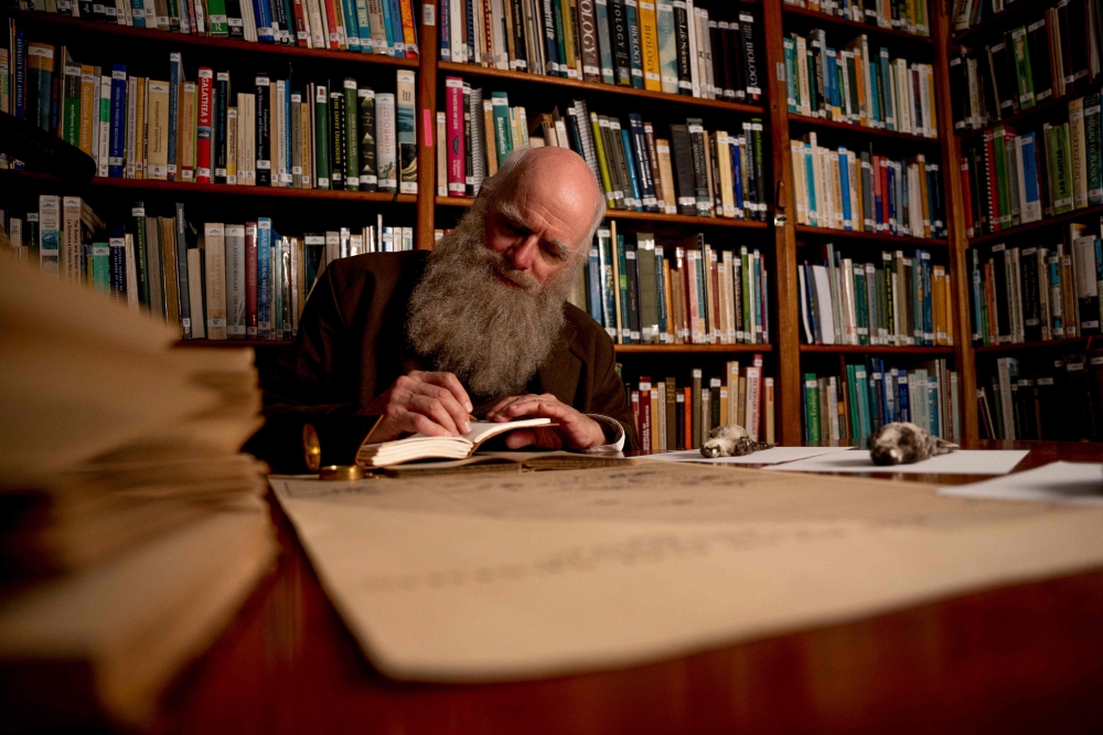 Kenneth Noll writes inside a library during an interview with AFP. — AFP pic