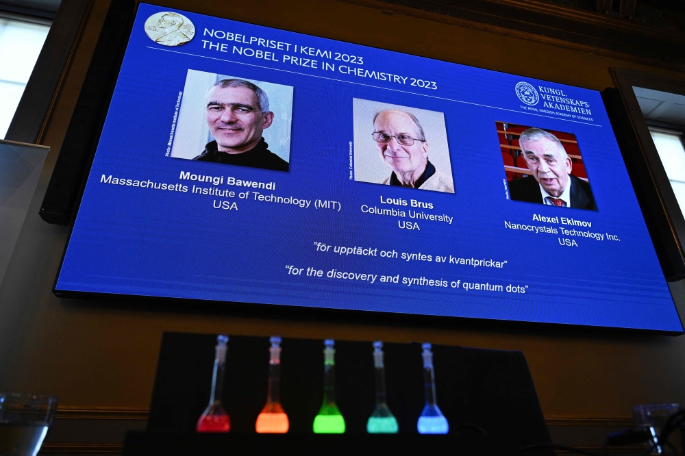 A screen shows this year's laureates US Chemist Moungi Bawendi, US Chemist Louis Brus and Russian physicist Alexei Ekimov after the announcement of the winners of the 2023 Nobel Prize in chemistry at Royal Swedish Academy of Sciences in Stockholm on October 4, 2023. — AFP pic
