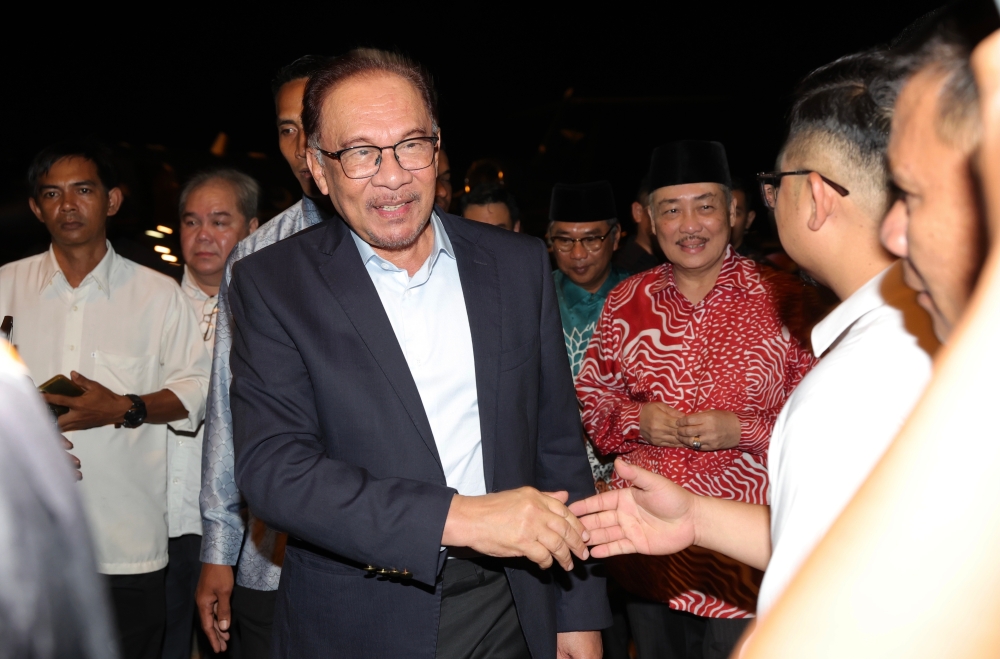 Prime Minister Datuk Seri Anwar Ibrahim greets guests at the Kota Kinabalu International Airport October 4, 2023. ― Bernama pic