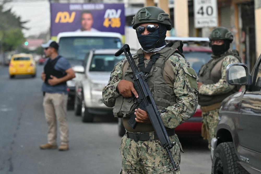 Security forces guard before the start of a caravan in support of Ecuadorian presidential candidate Daniel Noboa, of the National Democratic Action Party, in Guayaquil October 6, 2023. — AFP pic