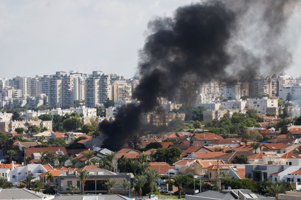 Smoke rises in the aftermath of rocket barrages that were launched from Gaza, in Ashkelon, Israel October 7, 2023. — Reuters pic