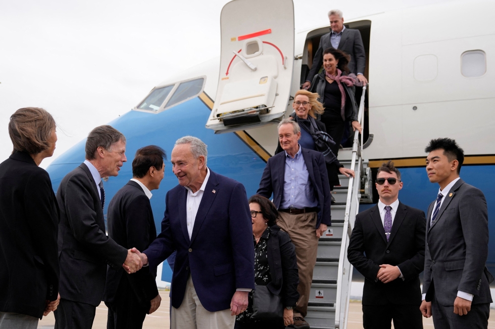 US Senate Majority Leader Chuck Schumer and other members of the delegation arrive at Shanghai Pudong International Airport in Shanghai October 7, 2023. — Reuters pic