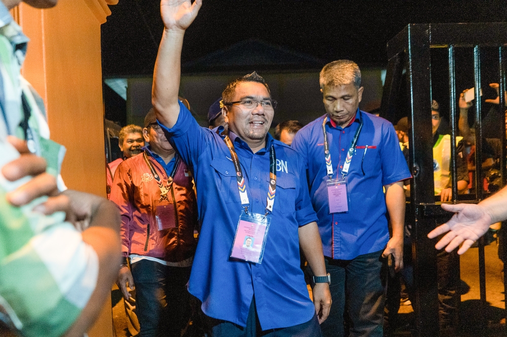 Newly-elected Pelangai member of Pahang state assembly, Amizar Abu Adam greets his supporters after the announcement of the Pelangai by-election result at Dewan Orang Ramai Felda Kemasol in Bentong October 7, 2023. — Picture by Shafwan Zaidon