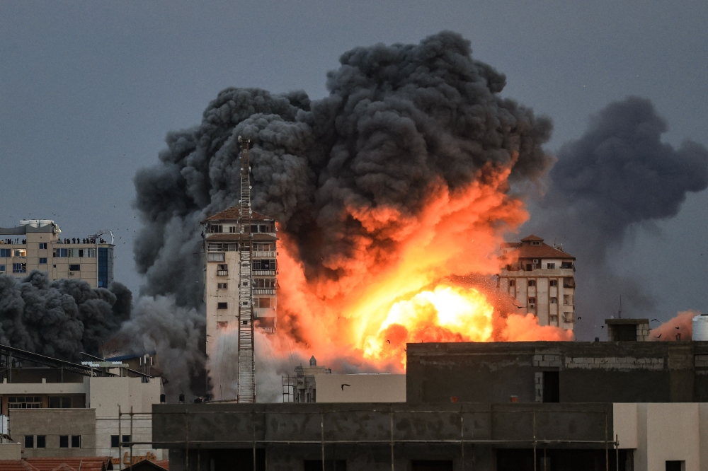 A ball of fire and smoke rises above a building in Gaza City. — AFP pic