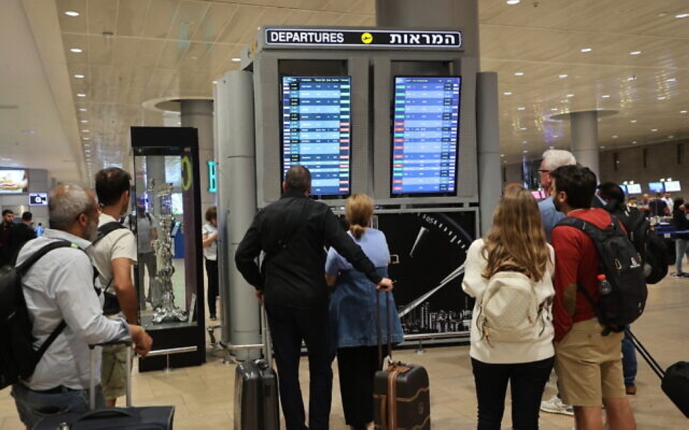 Passengers look at a departure board at Ben Gurion Airport near Tel Aviv, as flights are canceled and delayed because of a massive surprise attack by Hamas, on October 7, 2023. — AFP pic