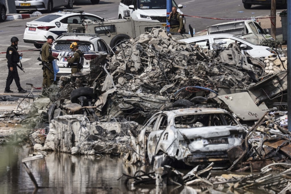 Security forces gather in front of an Israeli police station in Sderot after it was damaged during battles to dislodge Hamas militants who were stationed inside, on October 8, 2023. Israel's prime minister of October 8 warned of a 