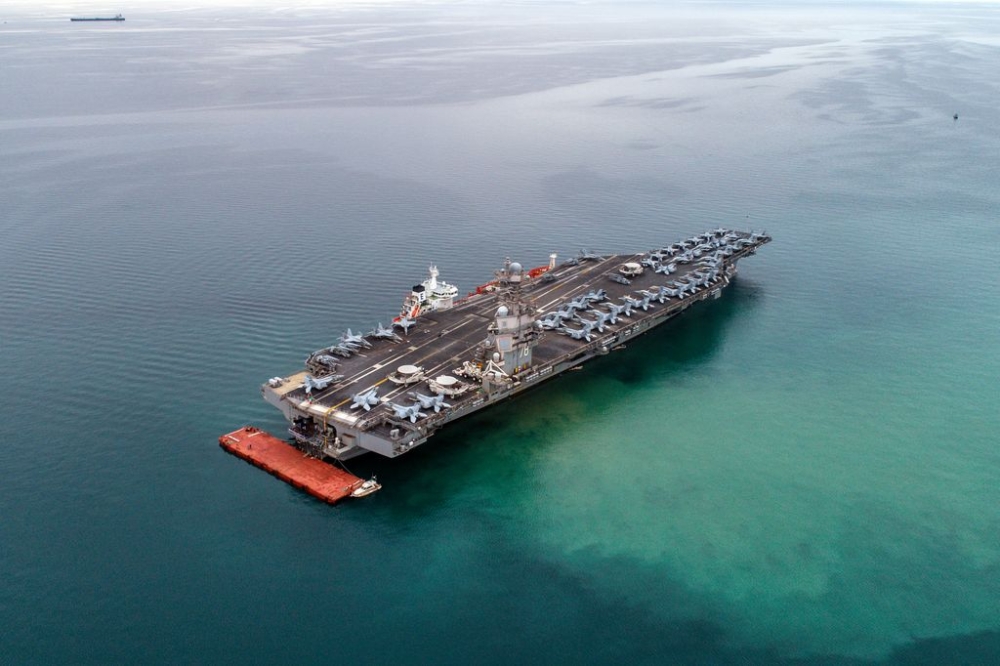 (Image taken with a drone) American aircraft carrier USS Gerald R. Ford as seen from the air anchored in Italy in the Gulf of Trieste. The USS Gerald R. Ford is the largest warship in the world. — SOPA Images via Reuters
