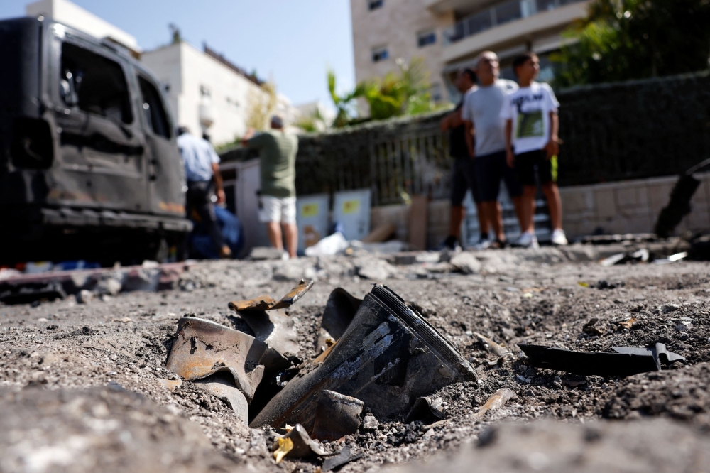 The remains of a rocket fired from the Gaza Strip into Israel lies on a road where it fell in Ashkelon, southern Israel, October 10, 2023. — Reuters pic